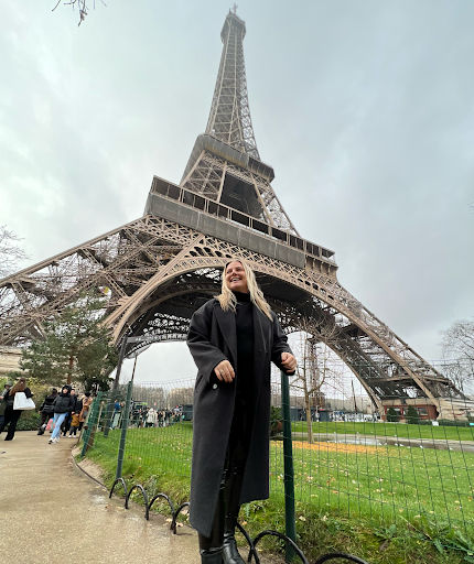 Abby standing in front of the Eiffel Tower in Paris.